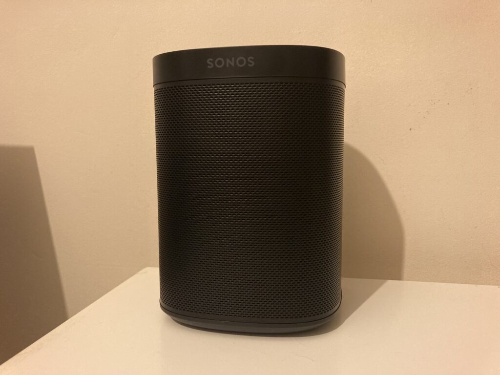 The Sonos One speaker sat on a white desk