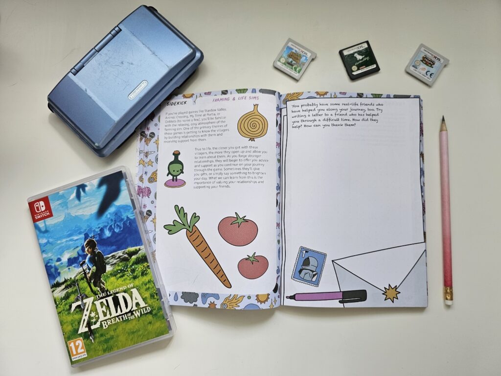The Sidekick journal lying open with video game memorabilia around it.